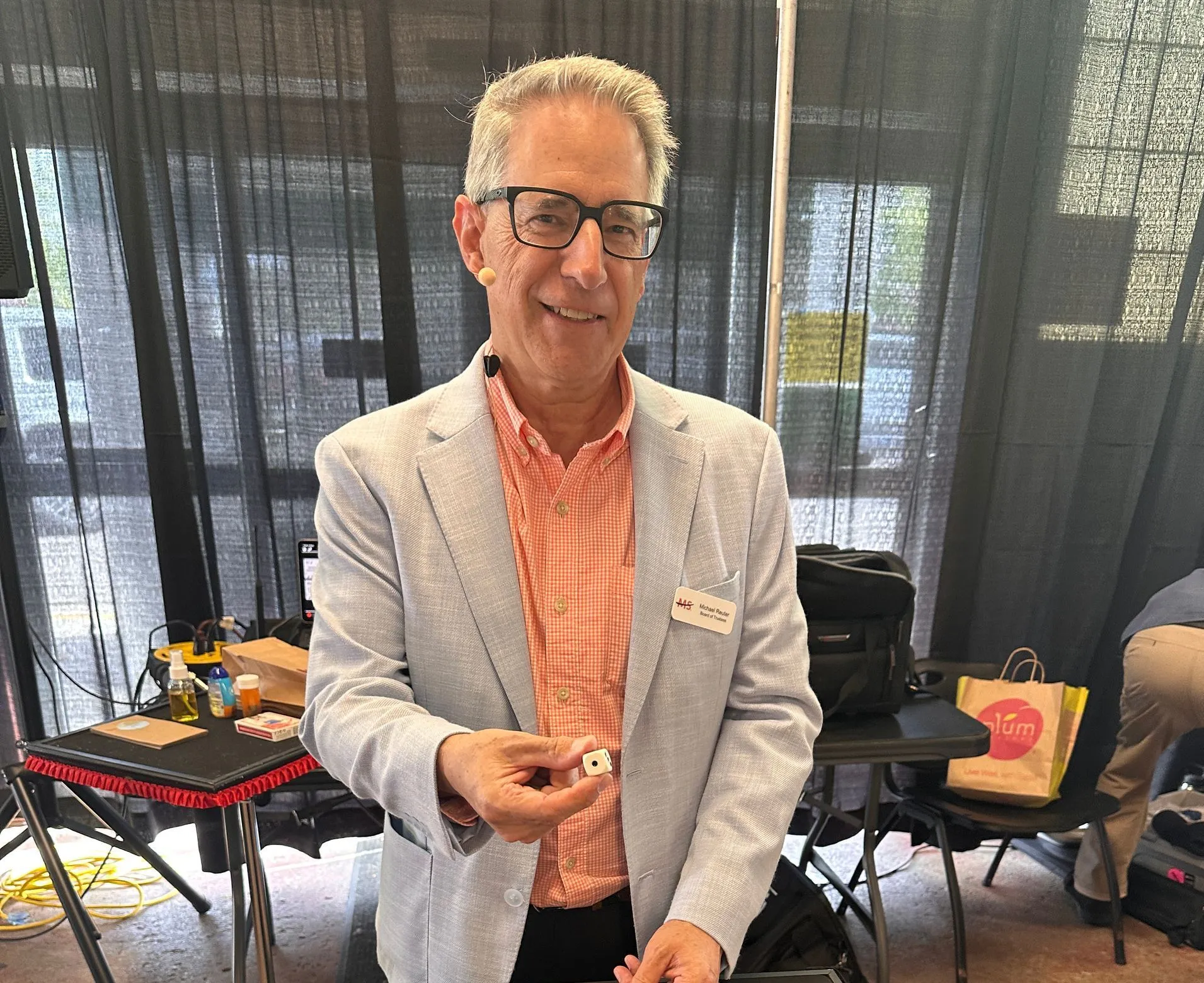 a photo of a magician standing and smiling